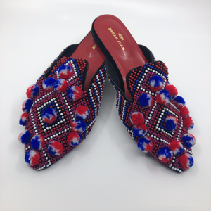 Batwing mules with pompoms